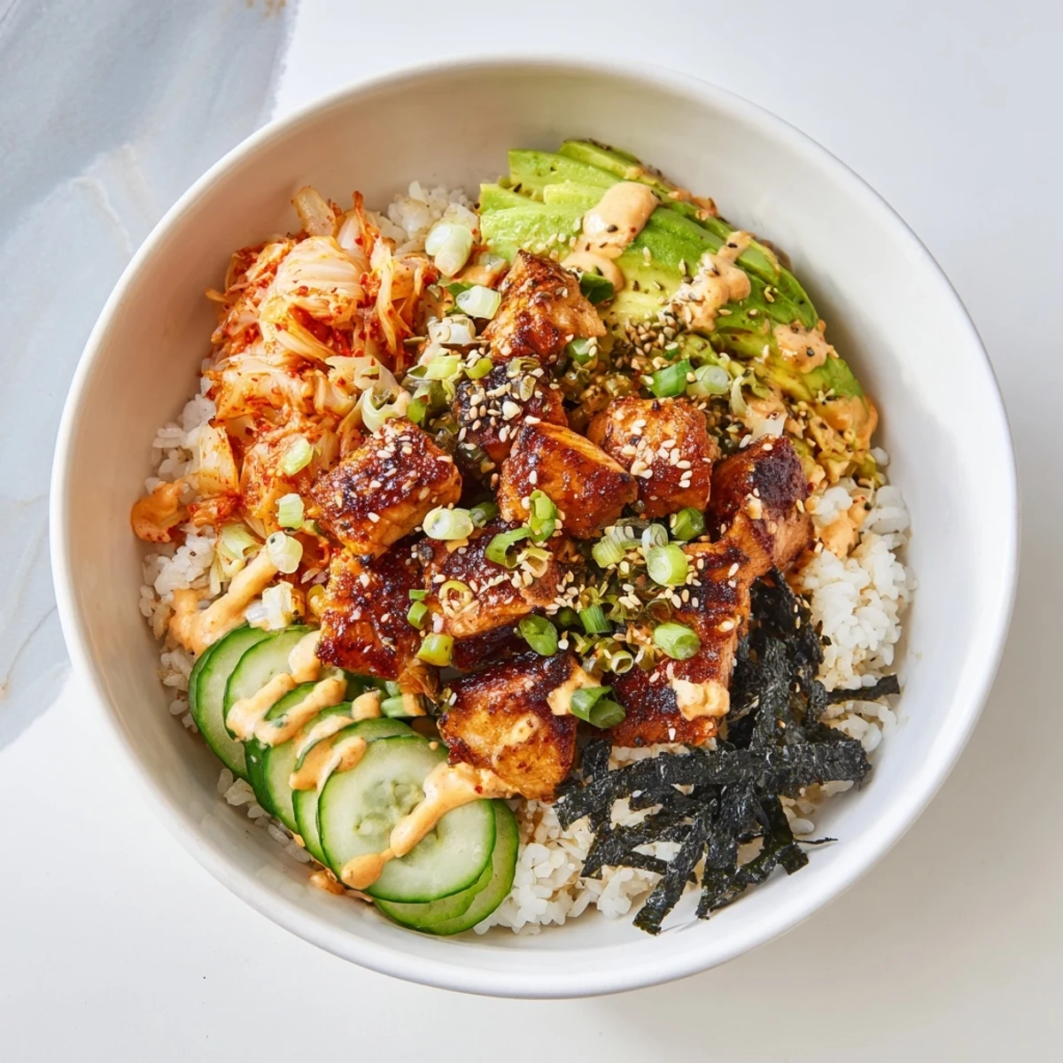 Crispy Salmon Rice Bowl with flavorful toppings, including avocado and spicy mayo drizzle.