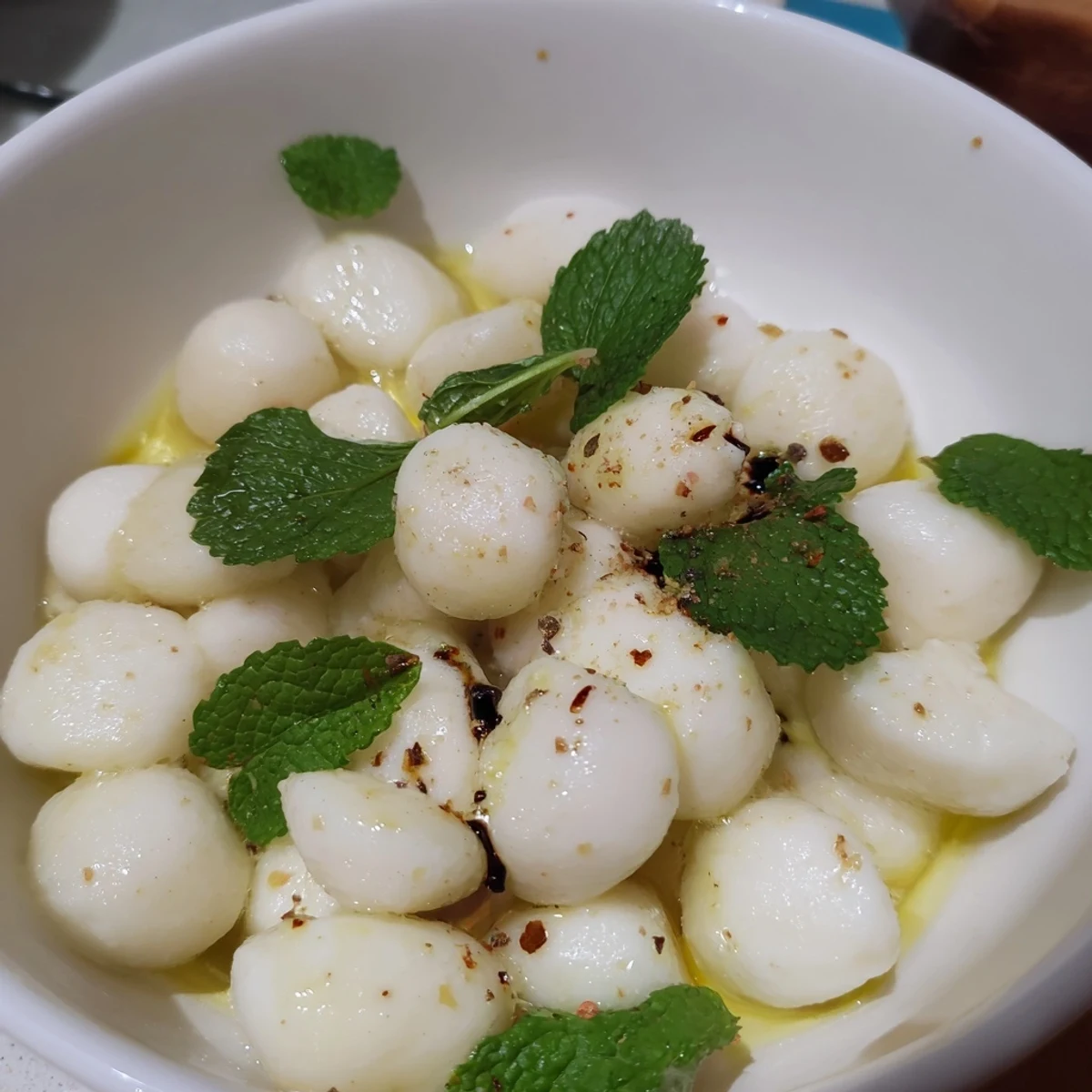 Creamy mozzarella pearls in a bowl, a simple Italian appetizer, ready to serve and enjoy.