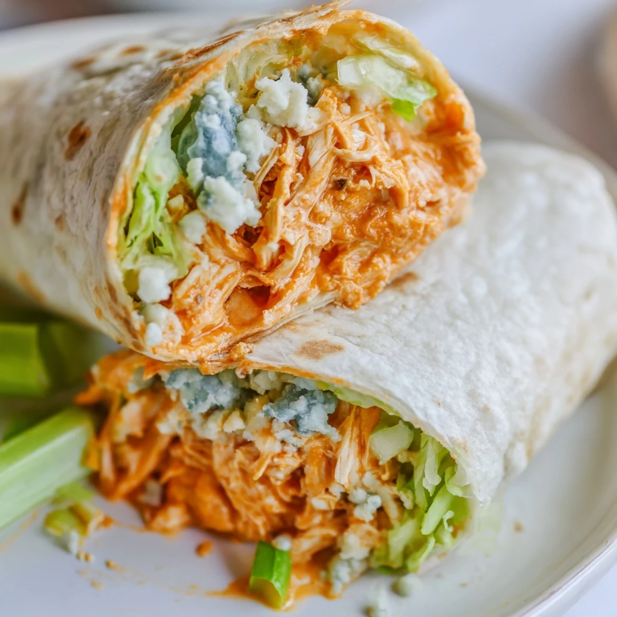 Sliced Buffalo Chicken Dip Wraps, with a tempting, melted cheese filling, perfect for a quick meal.