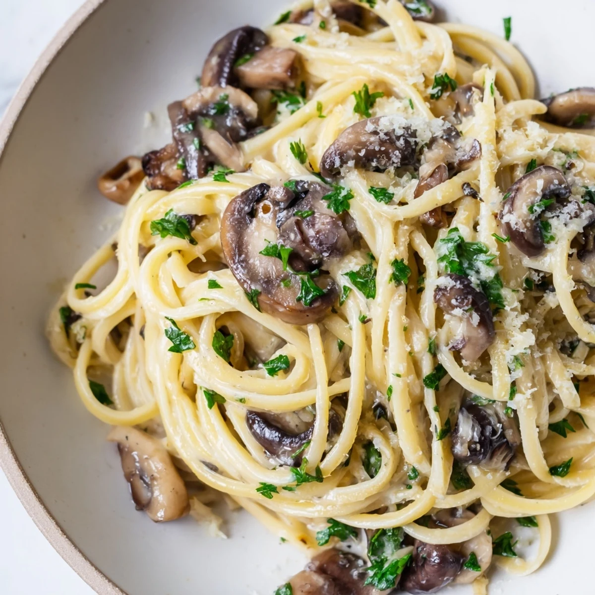 Al dente linguine coated in a silky cream sauce with golden sautéed mushrooms and fresh parsley.  