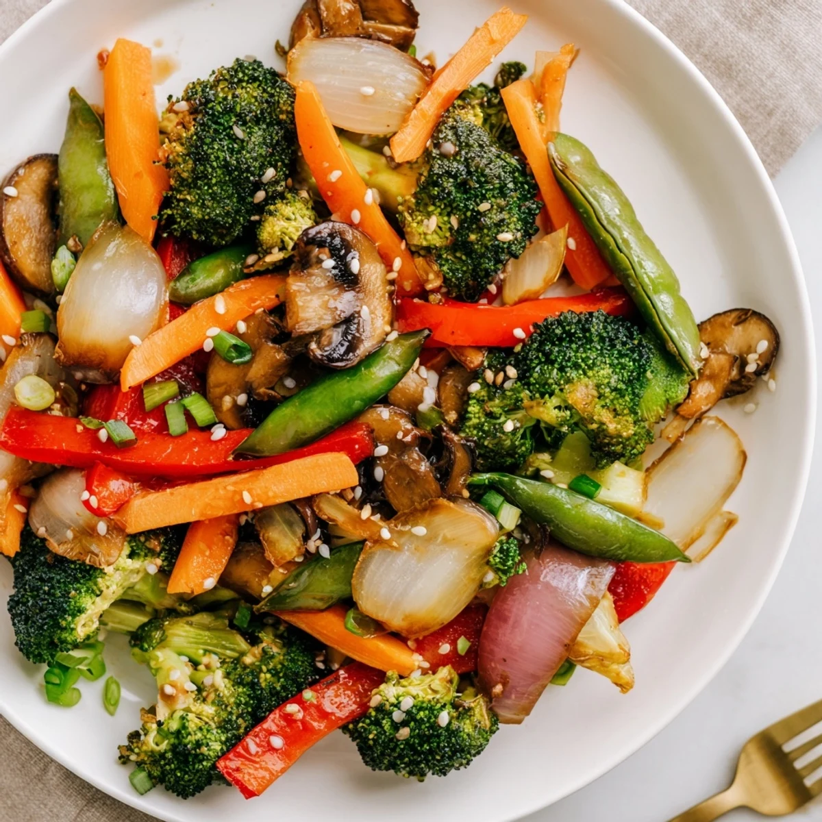 Hearty ginger stir-fried vegetables served over fluffy white rice in a ceramic bowl, featuring crisp veggies and savory sauce, perfect for a quick vegan dinner.