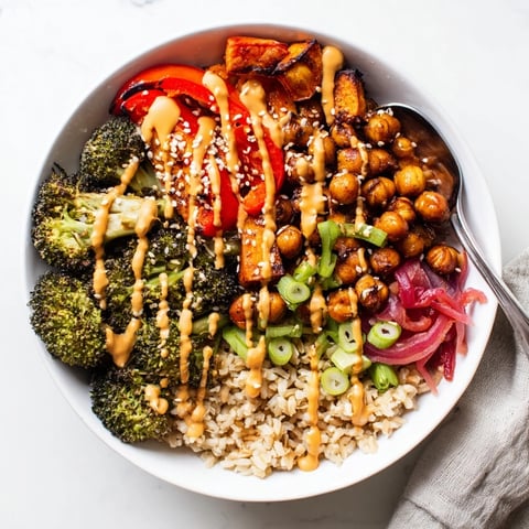 Vibrant Bold Sauce Drizzle Bowls topped with roasted veggies and flavorful sauces.