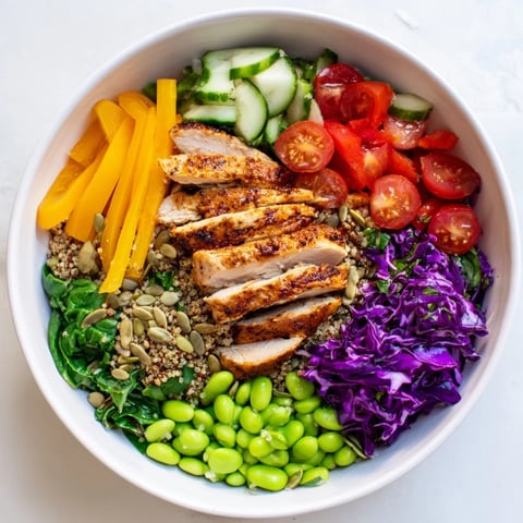 Colorful Healthy Meal-Prep Bowls filled with chicken, veggies, and zesty dressing.  