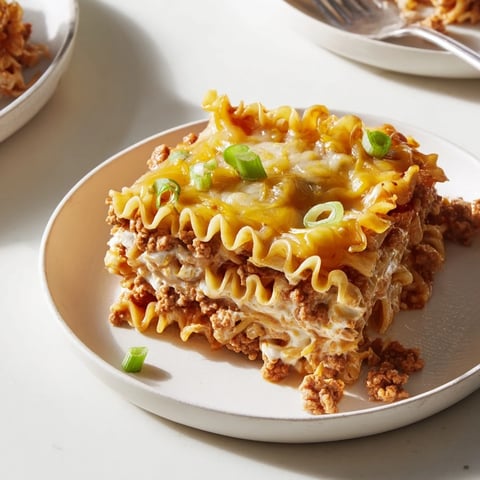 Layers of spicy ramen lasagna with creamy cheese and savory pork filling.  