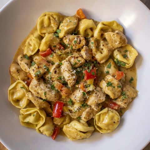 Creamy Zesty Cajun Garlic Parmesan Chicken Tortellini, a vibrant pasta dish ready for the dinner table.