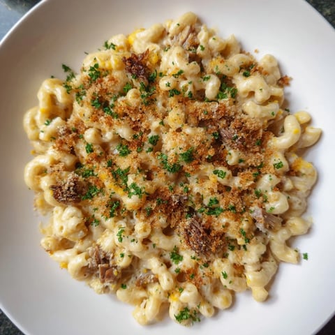 Golden-brown Barbecue Pulled Pork Mac and Cheese bubbling in a baking dish, ready to serve.