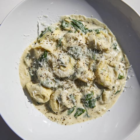 Creamy Spinach Alfredo Tortellini: A comforting bowl of pasta swimming in rich, cheesy Alfredo sauce.