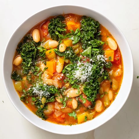 Steaming bowl of Italian Bean & Kale Stew, showcasing rustic textures and comforting aromas.