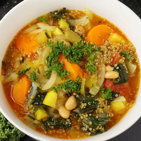 Steaming bowl of Minestrone with Quinoa & Winter Greens: a hearty, vibrant soup ready to eat.
