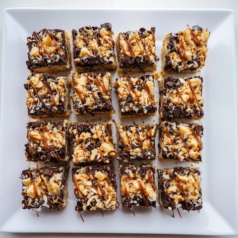 Golden, gooey 7-Layer Magic Bars topped with sea salt caramel, a perfect after-dinner dessert.