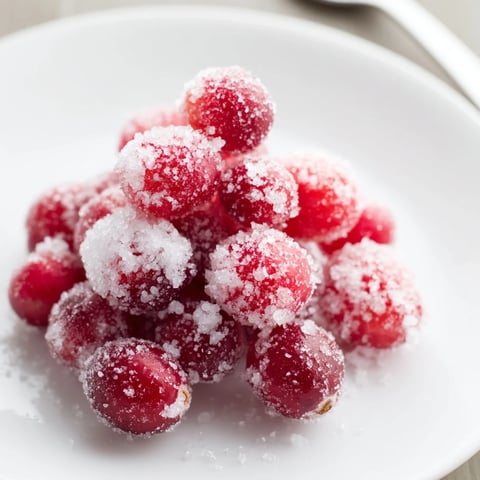 Shiny, sugared 5-Minute Express Candied Cranberries catch the light, a festive snack perfectly sugared.