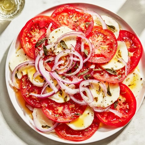 Golden, bubbling Speedy Feta-Free Tomato Bake topped with fresh basil, ready to serve with crusty bread.