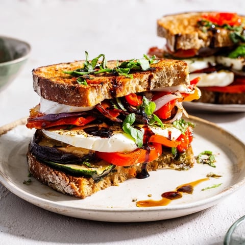 Golden, grilled and oozing: Sheet-Pan Roasted Veggie Caprese Grilled Cheese with fresh basil and melted mozzarella.