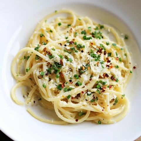 Steaming bowl of Miso Butter Pasta with glistening noodles and fresh herbs, ready to enjoy.