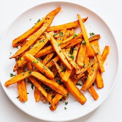 Golden, crispy Cajun Spiced Sweet Potato Fries, seasoned with herbs, a flavorful side dish.