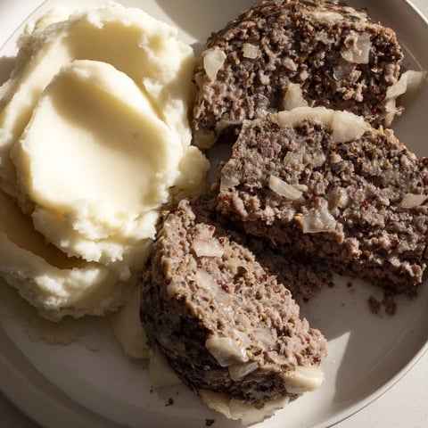 A delicious plate of traditional Scottish haggis, savory meat pudding served with mashed neeps and tatties.