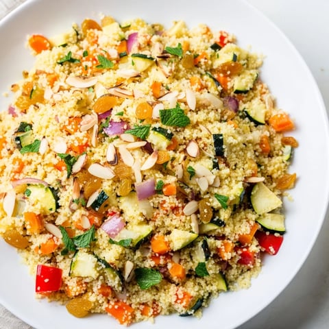 Fluffy Moroccan Couscous Salad with roasted vegetables, herbs, and a vibrant lemon dressing.
