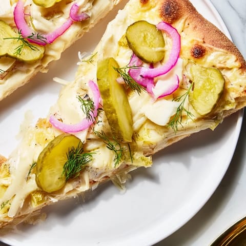 Delicious Pickle Pizza with melted mozzarella, crunchy dill pickles, and rich crème fraîche.  