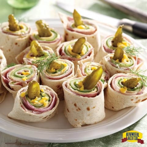 Colorful pickle-in-a-blanket appetizer ready for a fun summer picnic.  