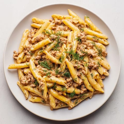 A close-up of a flavorful bowl of Turkish Pasta with Ground Turkey, creamy yogurt and tender pasta.