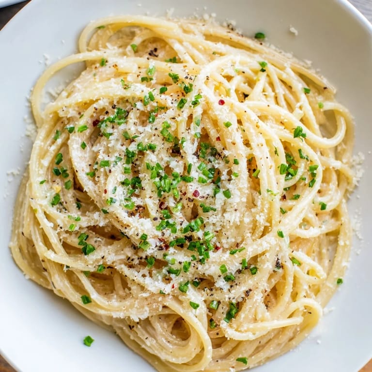 Savory Miso Butter Pasta, a quick and delicious main dish, sprinkled with parmesan and chives.