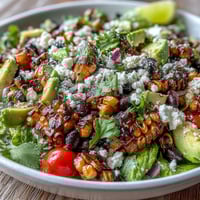 Vibrant grilled corn and black bean taco salad bursting with fresh flavors and lime dressing.